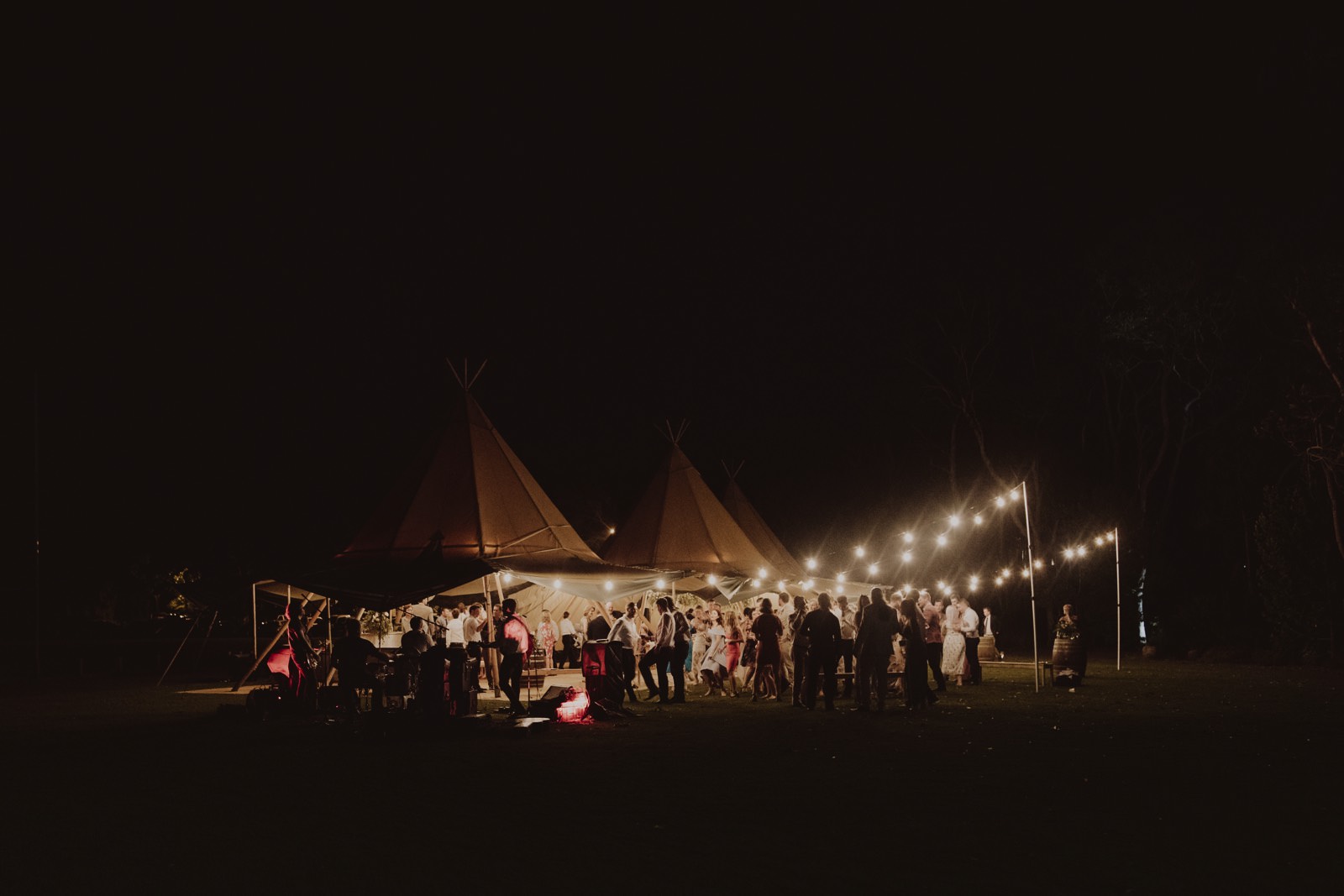 final scene of guests under the reception tipi