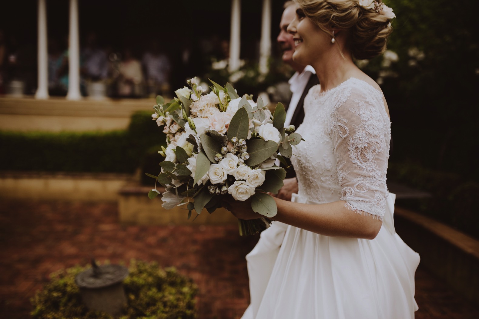 photo of bride walking down the aisle in rainy weather