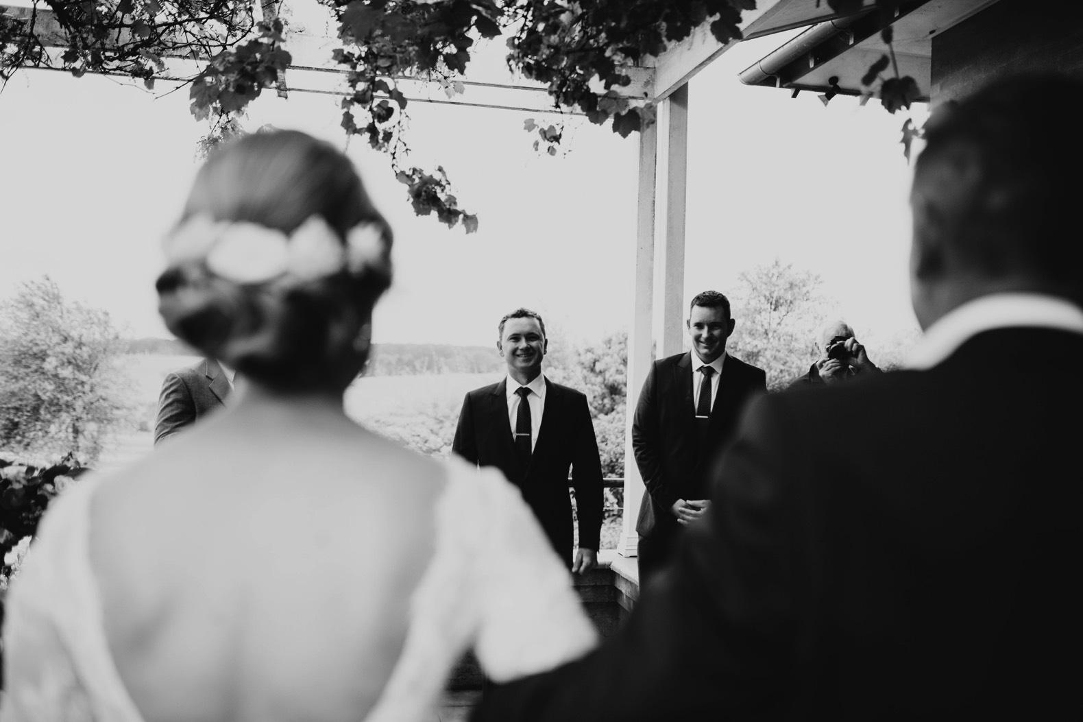 grooms face as bride is walking down the aisle