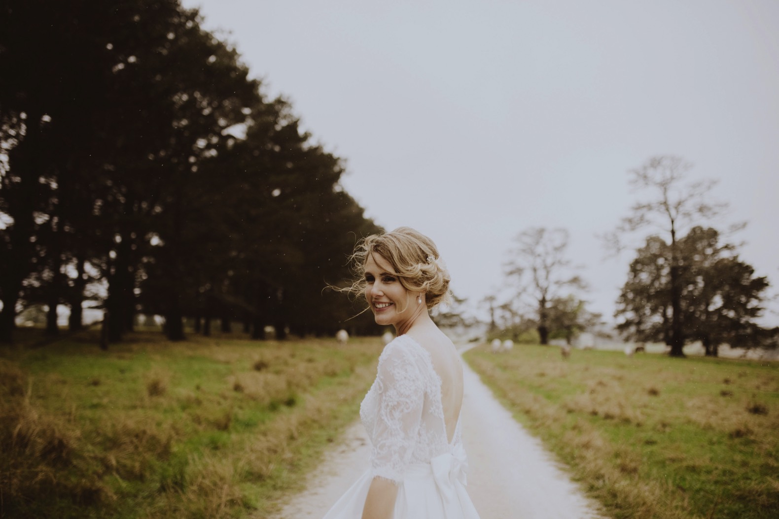 photo of bride standing in the rain in a field stanthorpe wedding photography